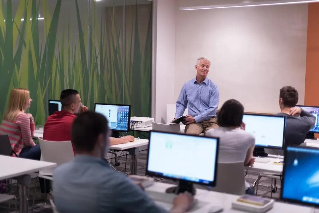 Teacher and students in a computer lab classroom